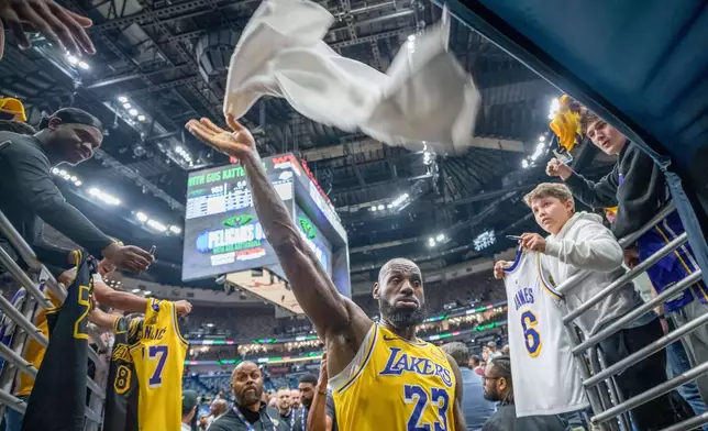 Los Angeles Lakers forward LeBron James (23) tosses his towel after a victory against the New Orleans Pelicans in an NBA basketball game in New Orleans, Tuesday, Jan. 6, 2026. (AP Photo/Matthew Hinton)