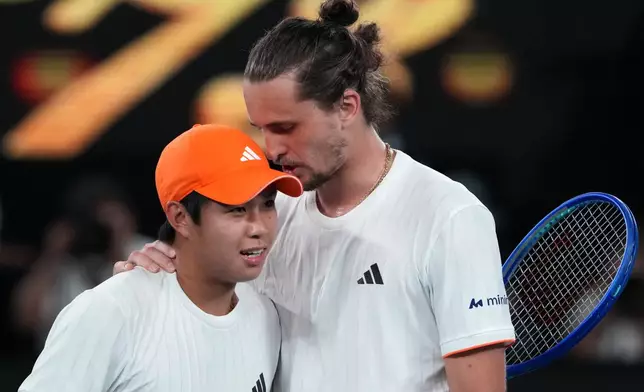 Alexander Zverev, right, of Germany is congratulated by Learner Tien, left, of the U.S. following their quarterfinal match at the Australian Open tennis championship in Melbourne, Australia, Tuesday, Jan. 27, 2026. (AP Photo/Aaron Favila)