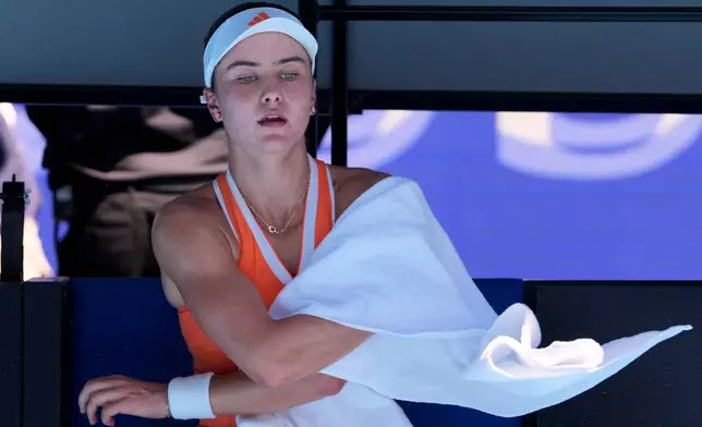 Iva Jovic of the U.S dries herself during her quarterfinal match against Aryna Sabalenka of Belarus at the Australian Open tennis championship in Melbourne, Australia, Tuesday, Jan. 27, 2026. (AP Photo/Aaron Favila)