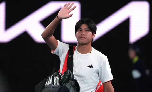 Learner Tien of the U.S. waves as he leaves the court following his quarterfinal loss to Alexander Zverev of Germany at the Australian Open tennis championship in Melbourne, Australia, Tuesday, Jan. 27, 2026. (AP Photo/Aaron Favila)