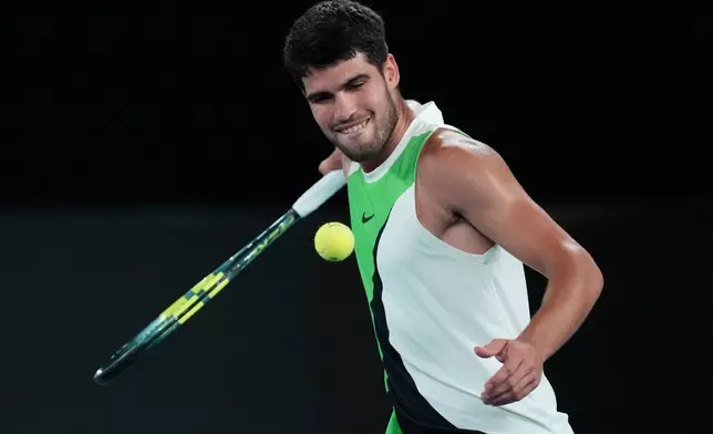 Carlos Alcaraz of Spain celebrates after defeating Alex de Minaur of Australia in their quarterfinal match at the Australian Open tennis championship in Melbourne, Australia, Tuesday, Jan. 27, 2026. (AP Photo/Dita Alangkara)