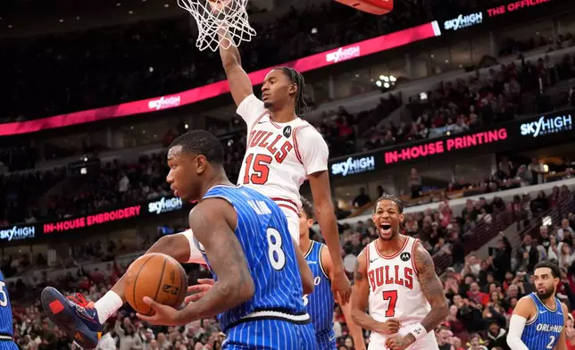 Chicago Bulls forward Julian Phillips (15) dunks the ball over Orlando Magic forward Jamal Cain (8) during the second half of an NBA basketball game, Friday, Jan. 2, 2026, in Chicago. (AP Photo/David Banks)