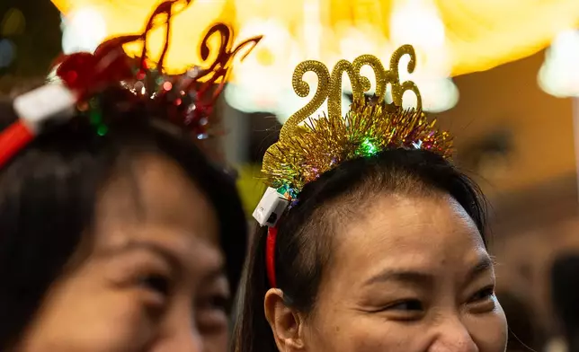 People attend the New Year countdown event to celebrate the start of 2026 in the Central district of Hong Kong, on Wednesday, Dec. 31, 2025. (AP Photo/Chan Long Hei)