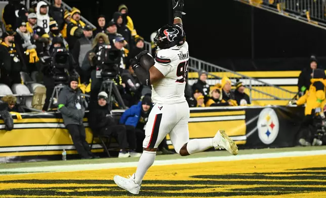 Houston Texans defensive tackle Sheldon Rankins runs to the end zone for a touchdown after recovering a fumble during the second half of an NFL wild-card playoff football game against the Pittsburgh Steelers, Monday, Jan. 12, 2026, in Pittsburgh. (AP Photo/Justin Berl)