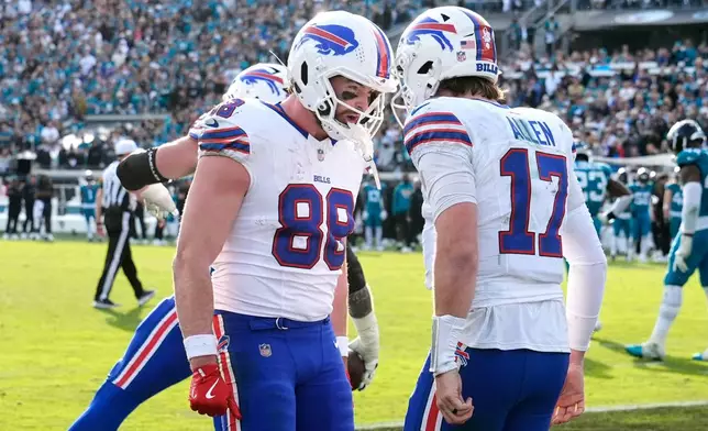 Buffalo Bills quarterback Josh Allen (17) celebrates his touchdown with tight end Dawson Knox (88) during the second half of an NFL wild-card playoff football game against the Jacksonville Jaguars Sunday, Jan. 11, 2026, in Jacksonville, Fla. (AP Photo/Chris O'Meara)