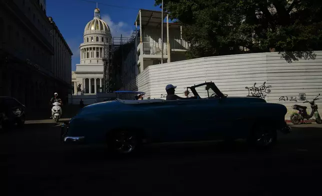 A man drives a classic American car in front of the Capitol in Havana, Monday, Jan. 26, 2026. (AP Photo/Ramon Espinosa)