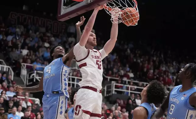 Stanford forward Aidan Cammann, middle, dunks against North Carolina guard Jaydon Young (4) during the first half of an NCAA college basketball game in Stanford, Calif., Wednesday, Jan. 14, 2026. (AP Photo/Jeff Chiu)