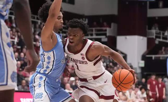 Stanford guard Ebuka Okorie, right, drives to the basket against North Carolina guard Seth Trimble during the first half of an NCAA college basketball game in Stanford, Calif., Wednesday, Jan. 14, 2026. (AP Photo/Jeff Chiu)