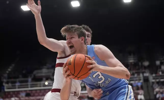 North Carolina center Henri Veesaar, right, drives to the basket against Stanford forward AJ Rohosy during the first half of an NCAA college basketball game in Stanford, Calif., Wednesday, Jan. 14, 2026. (AP Photo/Jeff Chiu)