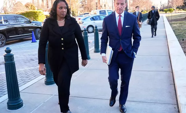 Federal Reserve governor Lisa Cook and attorney Abbe Lowell, arrive at the Supreme Court in Washington, Wednesday, Jan. 21, 2026. (AP Photo/Mark Schiefelbein)