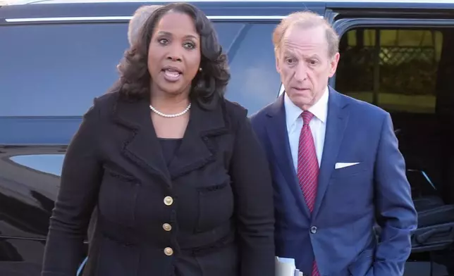 Federal Reserve governor Lisa Cook and attorney Abbe Lowell, arrive at the Supreme Court in Washington, Wednesday, Jan. 21, 2026. (AP Photo/Mark Schiefelbein)