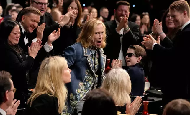 Amy Madigan, center, reacts to winning the award for best supporting actress for "Weapons" during the 31st Annual Critics Choice Awards on Sunday, Jan. 4, 2026, at The Barker Hanger in Santa Monica, Calif. (AP Photo/Chris Pizzello)