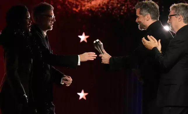 Teyana Taylor, from left, and Paul Thomas Anderson accept the award for best picture for "One Battle After Another" from Wagner Moura and Kleber Mendonca Filho during the 31st Annual Critics Choice Awards on Sunday, Jan. 4, 2026, at The Barker Hanger in Santa Monica, Calif. (AP Photo/Chris Pizzello)