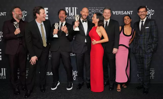Seth Rogen, from left, winner of the award for best actor in a comedy series for "The Studio," Ike Barinholtz, winner of the award for best supporting actor in a comedy series for "The Studio," James Weaver, Evan Goldberg, Chase Sui Wonders, Alex Gregory, Frida Perez and Peter Huyck, pose with the award for best comedy series for "The Studio" in the press room during the 31st Annual Critics Choice Awards on Sunday, Jan. 4, 2026, at The Barker Hanger in Santa Monica, Calif. (Photo by Jordan Strauss/Invision/AP)