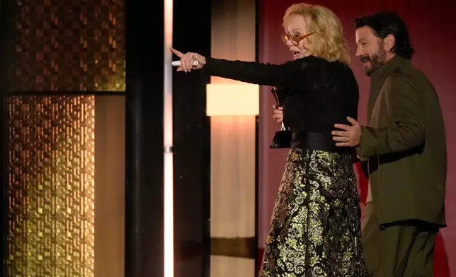 Diego Luna, right, presents Jean Smart the award for best actress in a comedy series for "Hacks" during the 31st Annual Critics Choice Awards on Sunday, Jan. 4, 2026, at The Barker Hanger in Santa Monica, Calif. (AP Photo/Chris Pizzello)