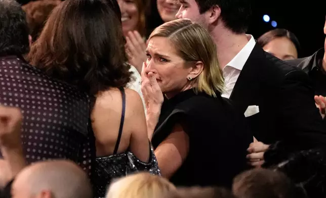 Rhea Seehorn, center, reacts to winning the award for best actress in a drama series for "Pluribus" during the 31st Annual Critics Choice Awards on Sunday, Jan. 4, 2026, at The Barker Hanger in Santa Monica, Calif. (AP Photo/Chris Pizzello)