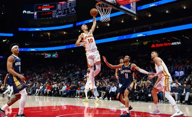 Atlanta Hawks forward Zaccharie Risacher (10) shoots over New Orleans Pelicans guard Bryce McGowens (11) during the first half of an NBA basketball game, Wednesday, Jan. 7, 2026, in Atlanta. (AP Photo/Colin Hubbard)