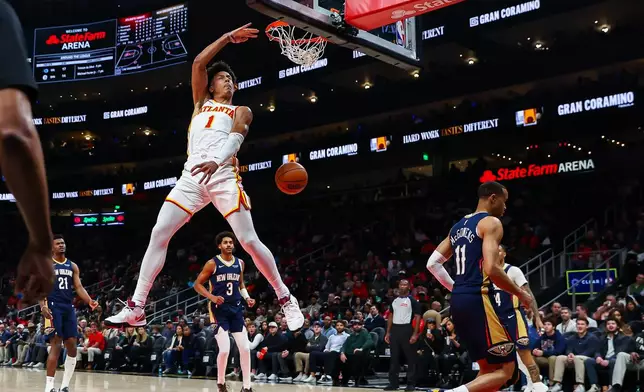 Atlanta Hawks forward Jalen Johnson (1) dunks against New Orleans Pelicans guard Bryce McGowens (11) during the first half of an NBA basketball game, Wednesday, Jan. 7, 2026, in Atlanta. (AP Photo/Colin Hubbard)