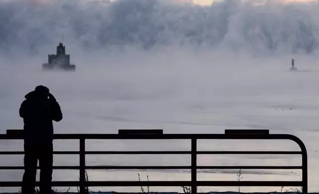 Doug Kunde watches as steam is seen over Lake Michigan as frigid temperatures for the day are not expected to reach zero degrees Friday, Jan. 23, 2026, in Milwaukee. (AP Photo/Morry Gash)