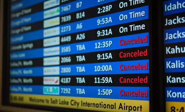 A flight status screen shows canceled flights to the Dallas-Fort Worth, Texas, area from the Salt Lake City International Airport amid a winter storm Saturday, Jan. 24, 2026, in Salt Lake City. (AP Photo/Sydney Schaefer)