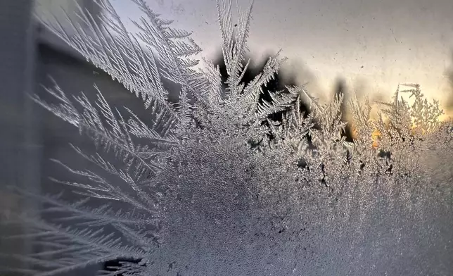 Ice crystals form inside a kitchen window in Lowville, New York, Saturday, Jan. 24, 2026. (AP Photo/Cara Anna)
