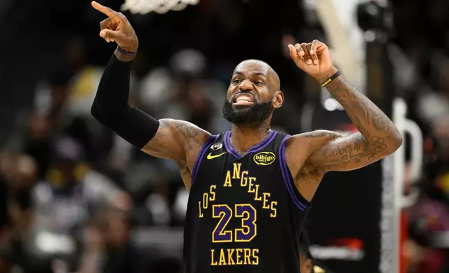 Los Angeles Lakers forward LeBron James gestures during the first half of an NBA basketball game against the Washington Wizards, Friday, Jan. 30, 2026, in Washington. (AP Photo/Nick Wass)