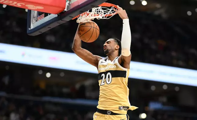 Washington Wizards center Alex Sarr dunks during the first half of an NBA basketball game against the Los Angeles Lakers, Friday, Jan. 30, 2026, in Washington. (AP Photo/Nick Wass)
