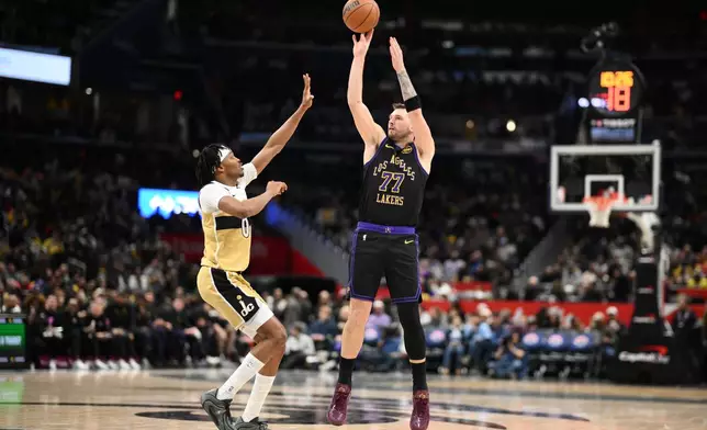 Los Angeles Lakers guard Luka Doncic (77) shoots against Washington Wizards guard Bilal Coulibaly (0) during the second half of an NBA basketball game, Friday, Jan. 30, 2026, in Washington. (AP Photo/Nick Wass)