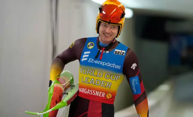 FILE - Max Langenhan of Germany smiles after the men's sprint race at the Luge World Cup in Igls near Innsbruck, Austria, Sunday, Dec. 8, 2024. (AP Photo/Matthias Schrader, File)