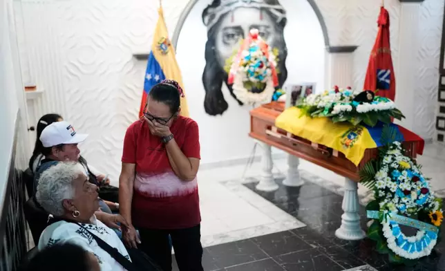 Ramona Palma, mother of Venezuelan soldier Cesar Garcia, mourns during his wake in Caracas, Venezuela, Wednesday, Jan. 7, 2026, after Garcia was killed in a U.S. raid that captured Venezuelan President Nicolas Maduro. (AP Photo/Matias Delacroix)