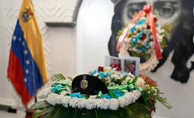 A military cap rests on the coffin of Venezuelan soldier Cesar Garcia, who was killed in a U.S. raid that captured Venezuelan President Nicolas Maduro, during his wake in Caracas, Venezuela, Wednesday, Jan. 7, 2026. (AP Photo/Matias Delacroix)