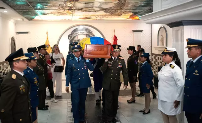 Members of the military carry the coffin of Venezuelan soldier Cesar Garcia, killed in a U.S. raid that captured Venezuelan President Nicolas Maduro, after his wake in Caracas, Venezuela, Wednesday, Jan. 7, 2026. (AP Photo/Matias Delacroix)