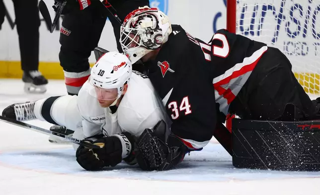 Los Angeles Kings right wing Corey Perry (10) collides with Buffalo Sabres goaltender Alex Lyon (34) during the second period of an NHL hockey game Thursday, Jan. 29, 2026, in Buffalo, N.Y. (AP Photo/Jeffrey T. Barnes)