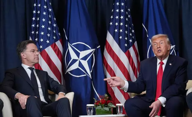 President Donald Trump, right, meets with NATO Secretary General Mark Rutte during a meeting on the sidelines of the Annual Meeting of the World Economic Forum in Davos, Switzerland, Wednesday, Jan. 21, 2026. (AP Photo/Evan Vucci)