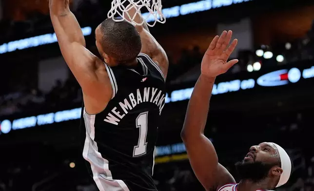San Antonio Spurs forward Victor Wembanyama (1) dunks against Houston Rockets guard Josh Okogie (20) during the first half of an NBA basketball game in Houston, Wednesday, Jan. 28, 2026. (AP Photo/Ashley Landis)