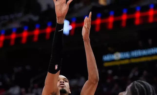 San Antonio Spurs forward Victor Wembanyama (1) shoots against the Houston Rockets during the first half of an NBA basketball game in Houston, Wednesday, Jan. 28, 2026. (AP Photo/Ashley Landis)