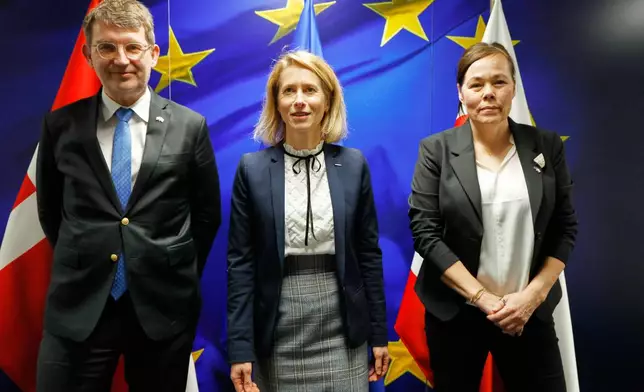 European Union foreign policy chief Kaja Kallas, center, greets Minister for Foreign Affairs and Research of Greenland Vivian Motzfeldt, right, and Denmark's Defense Minister Troels Lund Poulsen, left, prior to a meeting at EU headquarters in Brussels, Monday, Jan. 19, 2026. (AP Photo/Geert Vanden Wijngaert)