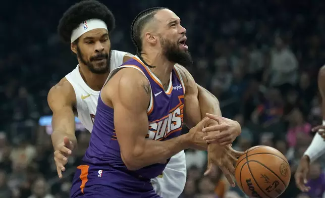 Phoenix Suns forward Dillon Brooks, right, is fouled by Cleveland Cavaliers center Jarrett Allen during the first half of an NBA basketball game Friday, Jan. 30, 2026, in Phoenix. (AP Photo/Ross D. Franklin)