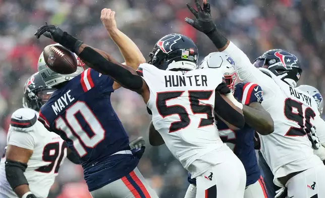 Houston Texans defensive end Danielle Hunter (55) sacks and forces New England Patriots quarterback Drake Maye (10) to fumble, which the Patriots recovered, during the first half of an NFL divisional playoff football game, Sunday, Jan. 18, 2026, in Foxborough, Mass. (AP Photo/Robert F. Bukaty)