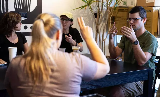 People attending a weekly meet up called "Sign Squad" communicate in American Sign Language at the Woodstock Cafe on June 10, 2025, in Portland, Ore. (Allison Barr/The Oregonian via AP)