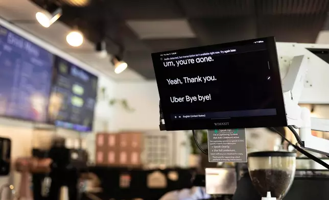 A screen displays words spoken by customers that comes from microphones translated onto screens is seen at the Woodstock Cafe on May 15, 2025, in Portland, Ore. (Allison Barr/The Oregonian via AP)