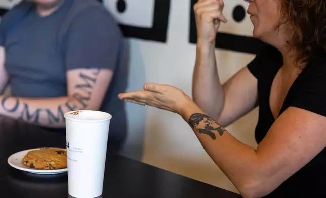 People attending a weekly meet up called "Sign Squad" communicate in American Sign Language at the Woodstock Cafe on June 10, 2025, in Portland, Ore. (Allison Barr/The Oregonian via AP)