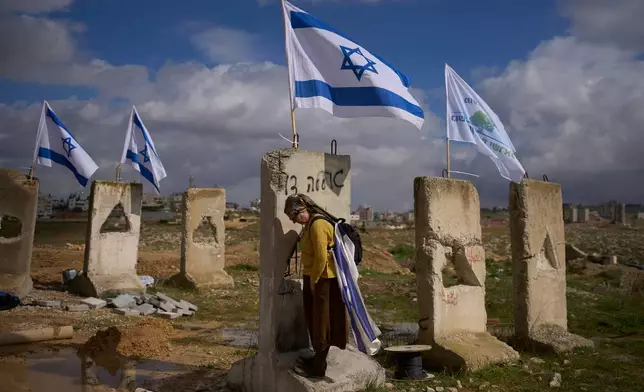 A woman attends the inauguration ceremony of a newly-legalized Jewish settlement, Yatziv, adjacent to the Palestinian town of Beit Sahour, in the West Bank, Jan. 19, 2026. (AP Photo/Ohad Zwigenberg)