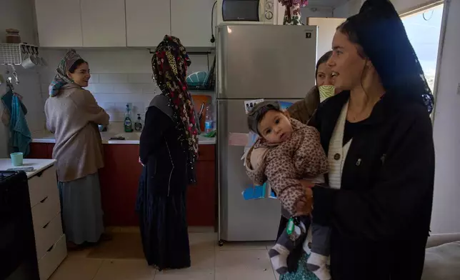 Israeli settlers and their children in the newly-legalized Jewish settlement of Yatziv, adjacent to the Palestinian town of Beit Sahour, in the West Bank, Jan. 19, 2026. (AP Photo/Ohad Zwigenberg)
