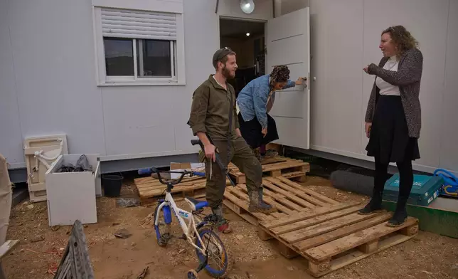 Israeli settlers talk in the newly-legalized Jewish settlement of Yatziv, adjacent to the Palestinian town of Beit Sahour in the West Bank, Jan. 19, 2026. (AP Photo/Ohad Zwigenberg)