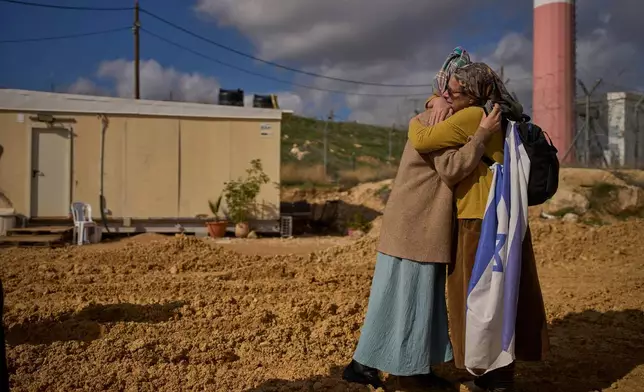 Settlers embrace at the inauguration ceremony for a newly-legalized Jewish settlement, Yatziv, adjacent to the Palestinian town of Beit Sahour, in the West Bank, Jan. 19, 2026. (AP Photo/Ohad Zwigenberg)
