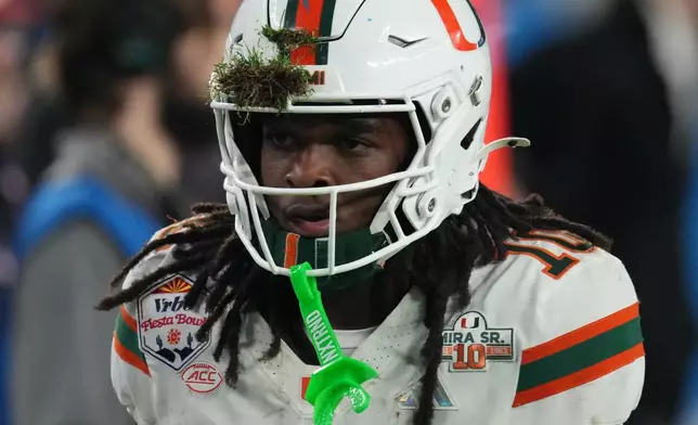 Grass is caught in the helmet of Miami wide receiver Malachi Toney during the first half of the Fiesta Bowl NCAA college football playoff semifinal game against Mississippi, Thursday, Jan. 8, 2026, in Glendale, Ariz. (AP Photo/Ross D. Franklin)