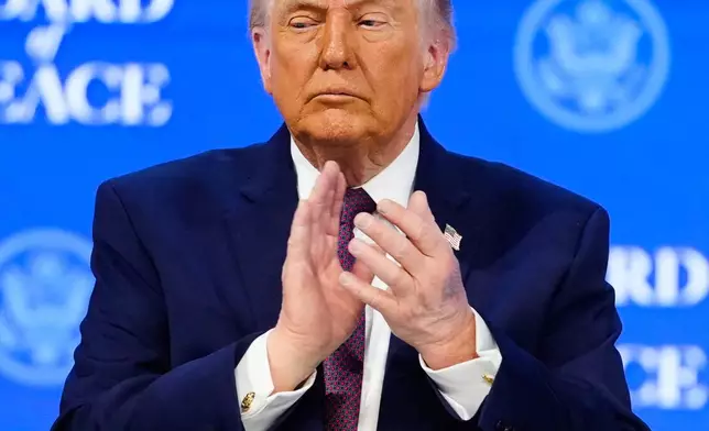President Donald Trump applauses during a signing ceremony on his Board of Peace initiative at the Annual Meeting of the World Economic Forum in Davos, Switzerland, Thursday, Jan. 22, 2026. (AP Photo/Markus Schreiber)