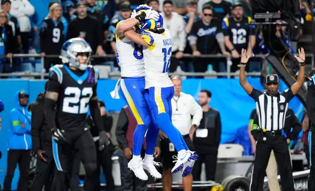 Los Angeles Rams tight end Colby Parkinson, center left, celebrates his touchdown catch with wide receiver Puka Nacua (12) during the second half of an NFL wild-card playoff football game against the Carolina Panthers, Saturday, Jan. 10, 2026, in Charlotte, N.C. (AP Photo/Erik Verduzco)