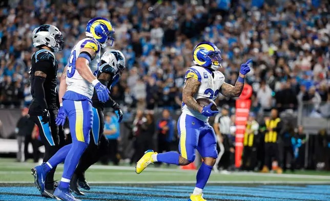 Los Angeles Rams running back Kyren Williams, right, scores a touchdown during the second half of an NFL wild-card playoff football game against the Carolina Panthers, Saturday, Jan. 10, 2026, in Charlotte, N.C. (AP Photo/Rusty Jones)